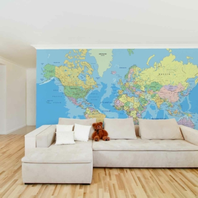 The wallpaper is a detailed world map mural, featuring earth tones and subtle shades of blue, green, and beige. It provides a geographical touch with intricate coastlines, countries, and continents clearly depicted. The design combines muted colors to create a sophisticated backdrop for the living room.