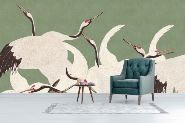 Mural of elegant white cranes, black-tipped wings, red-crowned heads, muted green background.