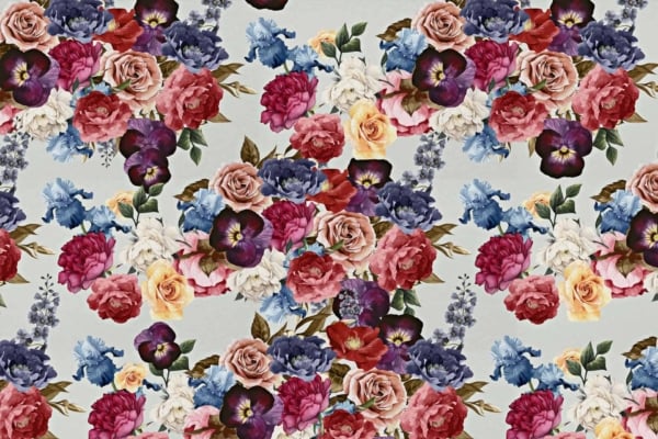 Seamless floral wallpaper features detailed roses, peonies, pansies, and other flowers. Colors include shades of red, pink, blue, purple, and cream. The lush blooms cascade against a light background for a rich and vibrant design.