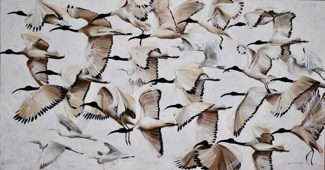Nature-inspired wallpaper featuring a dynamic flock of migratory birds in flight, including ibises and egrets with wings spread wide. Feathers showcase shades of white, cream, and light brown against a pale, cloudy sky. Perfect for 2021 home decor trends.