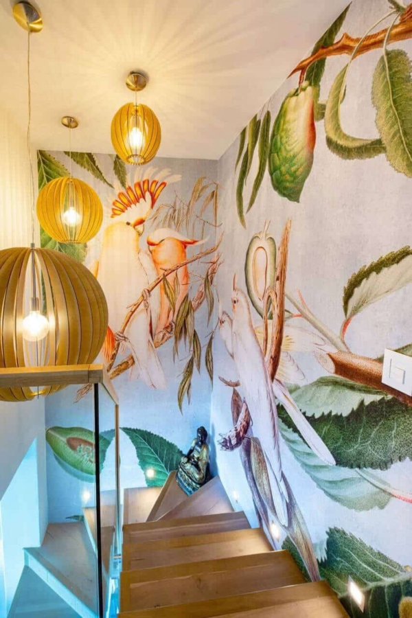 Large, colorful murals of exotic birds and tropical foliage.