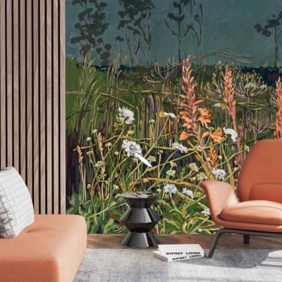 A large wall mural features vibrant nature with green grass, orange flowers like Scabiosa and Watsonia blooms, and trees.