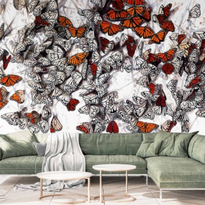 Vibrant butterflies in shades of orange and black, with a few in white and black.