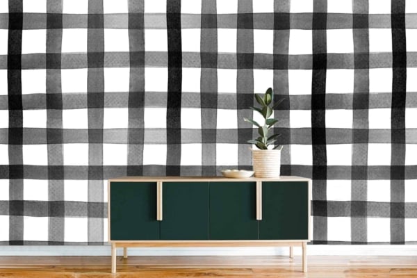 The wallpaper features a black and white gingham checkered pattern. The colors are strictly monochrome, involving stark black checks alternating with crisp white ones in a regular grid format. This pattern is bold yet classic, adding a timeless visual element to the room without overwhelming it.