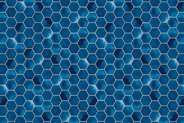 Seamless wallpaper pattern of blue hexagonal tiles, white outlines. Varied shades of blue create a mosaic effect. Subtle watercolor textures add depth and variation. Visually busy yet harmonious design.