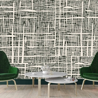 A modern living room features a striking black and white geometric patterned wall. Elements include bold, intertwining lines and shapes that create an eye-catching contrast. The wallpaper's colors are limited to black and white, enhancing its contemporary look. Ideal for those searching for monochrome, geometric designs.