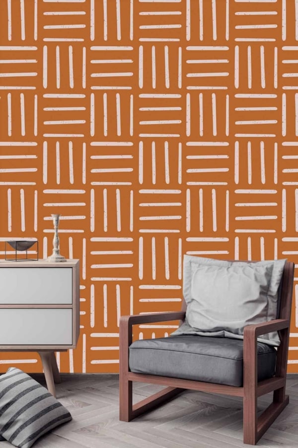 The wallpaper features an orange background adorned with a white geometric pattern.