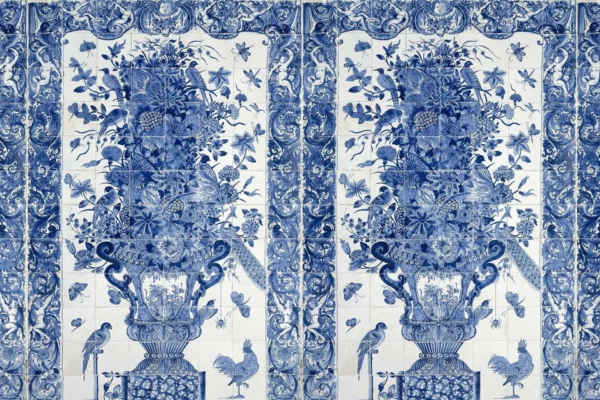 A detailed wallpaper design inspired by a blue and white tile mural features intricately painted images of birds, butterflies, and various flowers arranged in an ornate vase. The classic French aesthetic is represented with symmetry and elaborate borders framing the central composition. Key elements include intricate birds, butterflies, floral arrangements, ornate vase details, symmetrical design, and elaborate borders—all rendered in classic blue and white hues.