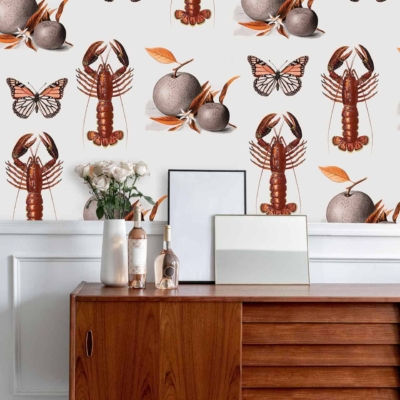 The whimsical Nineteen Eighty wallpaper features illustrations of lobsters, butterflies, oranges, and autumn leaves. The design incorporates vibrant colors including reds (lobsters), blues and yellows (butterflies), oranges (fruits), and various shades of browns and reds (autumn leaves).