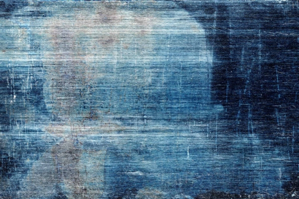 Textured abstract wallpaper with layered hues of blue and white, evoking weathered paint or a roughed-up surface. Subtle hints of beige and light brown add depth, suggesting the passage of time and natural wear.