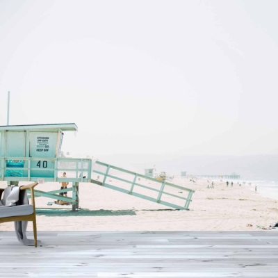 Wallpaper features: serene beach scene, large floor-to-ceiling window, lifeguard tower labeled 