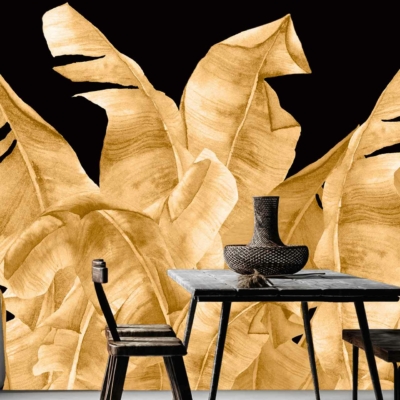 The wallpaper features a bold mural with golden tropical leaves against a black backdrop, creating striking contrast and artistic flair.