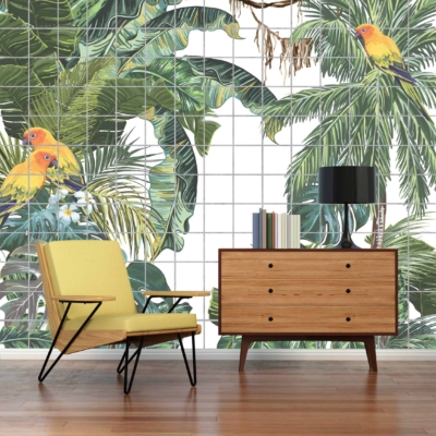A large wall mural featuring lush Sub Tropicana foliage in vibrant greens, with bright, multicolored parrots in vivid reds, blues, and yellows. Rich botanical elements and tropical bird designs dominate the wallpaper's landscape.