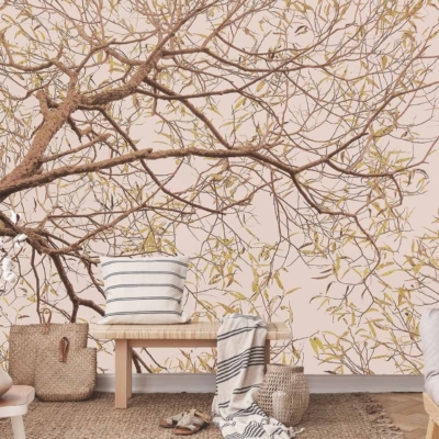 The wallpaper showcases a stunning, serene mural of a tree with intricate branches and foliage. The hues range from warm browns and lush greens to soft golden tones, encapsulating the tranquility of nature. This vibrant depiction serves as an elegant backdrop, bringing the essence of an outdoor sanctuary into the cozy room.