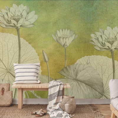 A large wall mural featuring oversized green lotus flowers and leaves set against a sunset-colored gradient background. The wallpaper highlights vibrant greens in the floral designs, complemented by warm shades of orange, pink, and purple in the gradient backdrop.
