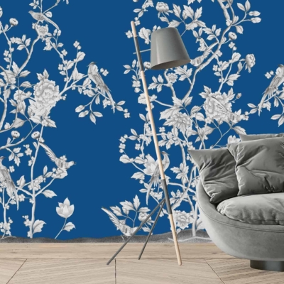 Vibrant blue wallpaper with intricate white floral and bird patterns, reminiscent of the opulence of the Palace of Versailles.