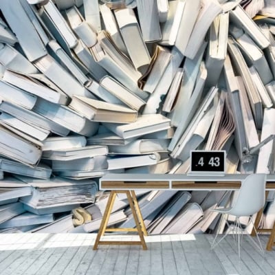 The wallpaper features an artistic depiction of abundant knowledge with white books stacked haphazardly, highlighting a minimalist yet striking design. The primary element is the large array of white books, creating a visually stimulating backdrop with its detailed and organized chaos.