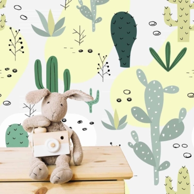 The wallpaper features whimsical, Arizona-inspired designs with a variety of cactus illustrations and doodles. It includes various shades of green and yellow. Cactus types depicted range from tall saguaro cacti to round barrel cacti. The playful patterns create a vibrant and lively backdrop, capturing the essence of the desert landscape.