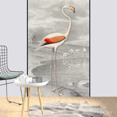 A Minimalist room with a white wall features a large, vibrant illustration of flamingos by water. The wallpaper showcases soft pink and coral hues of the flamingos, contrasting with the blue and green tones of the water and surrounding foliage. Splashes of gentle pastels evoke a romantic