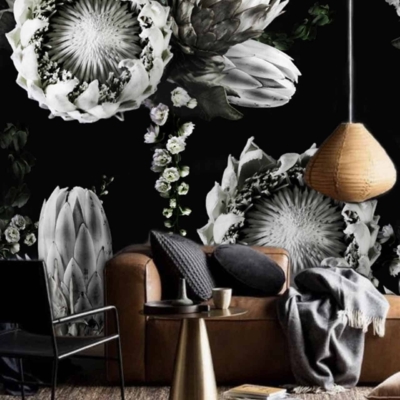 The Caro dark floral wallpaper features large, detailed flowers in black, white, and grey tones.