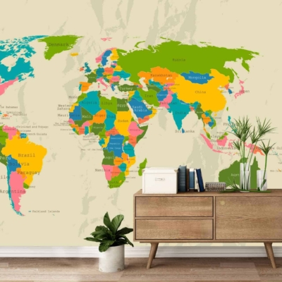 A vibrant world map decal on a beige wall featuring countries in bright colors reminiscent of Colour Run hues. Major city names labeled across the colorful continents. The decal includes an adjacent white door.