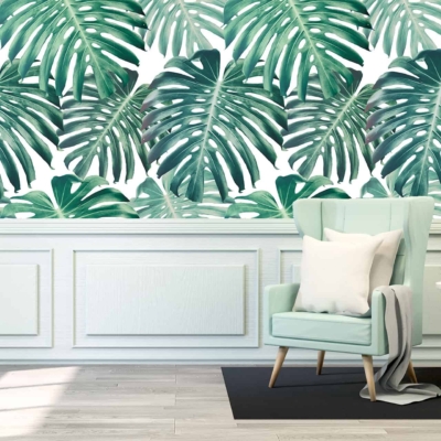 Vibrant tropical leaf pattern, featuring bold green leaves with hints of blue and yellow on a white background.