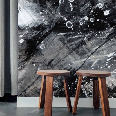 The wallpaper features an abstract design with black, white, and gray colors. It includes paint splatters and brush strokes, creating a dynamic and modern look.