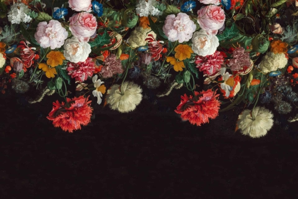 A lavish floral arrangement wallpaper with cascading red, white, and pink peonies, yellow daisies, and blue blossoms. Set against a dark background.