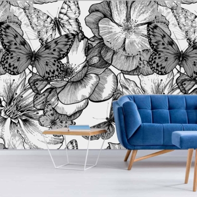 The wallpaper in the modern living room features large, intricate black and white floral designs, complemented by elegant butterfly motifs. The butterflies symbolize the grace of their first flight, creating an eye-catching and artistic backdrop. This monochromatic palette brings sophistication and contrast to the room.