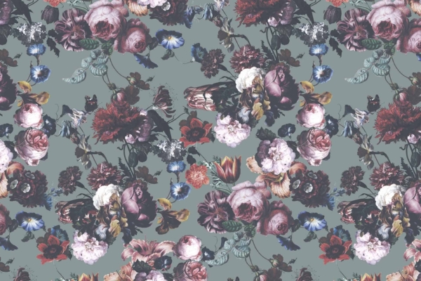 A repeating floral pattern wallpaper featuring roses, tulips, and peonies in shades of pink, red, and purple. The background color is a muted greenish-gray. Intricately detailed flowers are densely packed throughout the design, evoking a vintage aesthetic reminiscent of past generations.