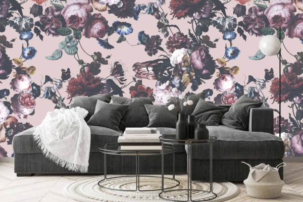 Floral-patterned wallpaper, vintage-inspired, featuring various flowers on a pink background. Elegant blooms in shades of red, yellow, blue, and green are delicately intertwined with leafy vines to create a classic and detailed design. Perfect for adding a touch of nostalgia and charm to modern spaces.