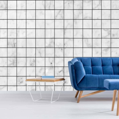 White marble squares tiled on the wall with thin, black grout lines, resembling graph paper.