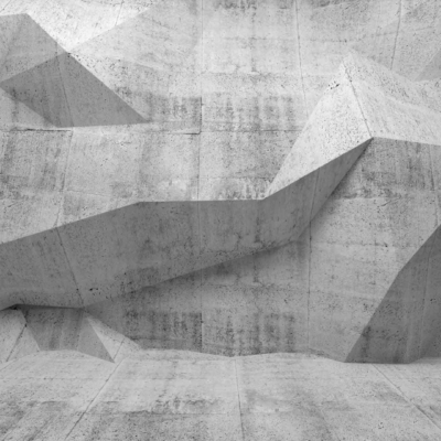 A monochromatic wallpaper featuring an abstract concrete wall with sharp, angular geometric shapes and varying depths. The surface is rough and textured, with a guarded, sculptural quality. Colors are muted shades of gray, highlighting the contrasts and shadows of the geometric elements.