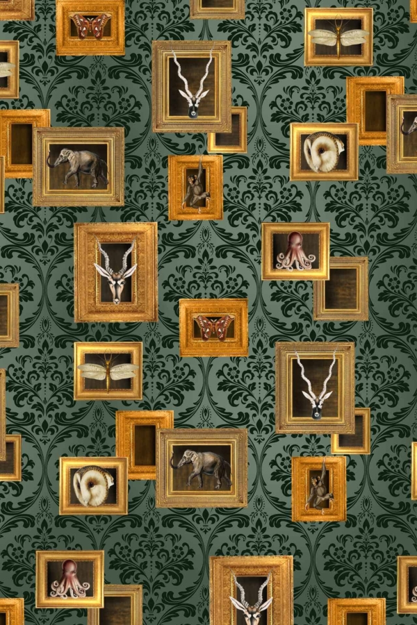 A vivid green patterned wallpaper featuring intricate scrollwork and botanical motifs in various shades of emerald and forest green. Delicate gold accents highlight certain elements, adding a touch of opulence. The overall design gives off a lush, sophisticated ambiance that complements the eclectic collection of shadow boxes adorning it.