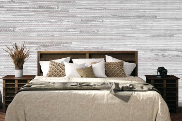 The wallpaper behind the bed features a textured gray and white pattern. This design blends distinct shades of gray with crisp whites, creating a subtle yet sophisticated backdrop for the cozy bedroom.