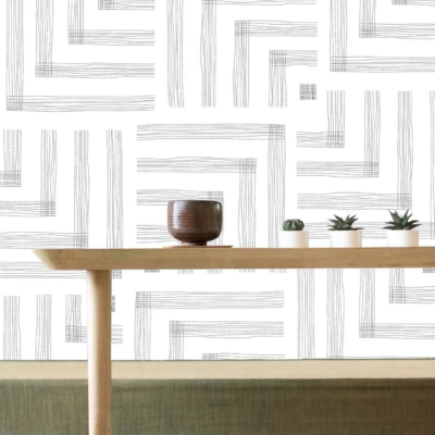 The modern white wall features abstract linear patterns. These lines are subtle yet add depth to the minimalist design. The color scheme is primarily white, with the linear patterns in light grey tones. The overall effect is clean and understated, perfect for a minimalist aesthetic.