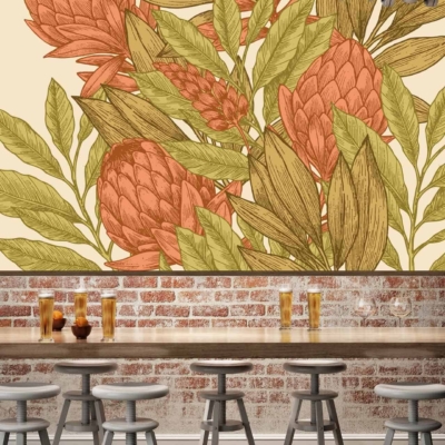 In the heart of Lower Slopes, a cozy cafe features a large, colorful mural on its brick wall. The mural bursts with vibrant shades of green and purple artichokes intertwined with lush, verdant leaves. Hints of yellow and rust-red add warmth and depth to the foliage. This lively wallpaper adds an element of natural beauty and artistic flair that anchors the space's aesthetic charm.
