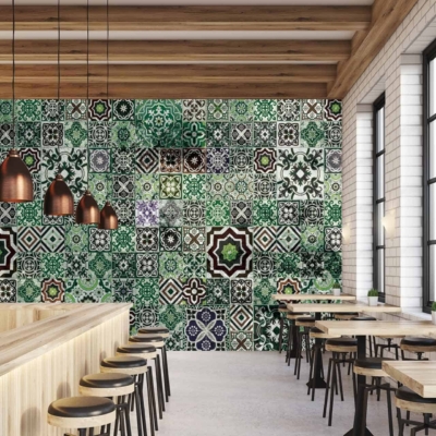 Vibrant wall with geometric tiles in green, black, and white, reminiscent of Marrakech.