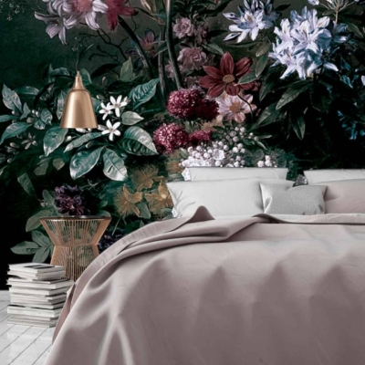 The wallpaper features a large floral mural with detailed, vibrant blooms in shades of pink, red, and orange, set against lush green foliage. Delicate vines weave through the flowers. The design is intricate, showcasing soft petal textures and realistic leaf patterns.