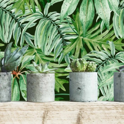The wallpaper features vibrant green tropical leaves in various shades of green, with hints of lighter greens and deep forest tones. The leaves are lush and detailed, creating a rich, natural look that stands out against any backdrop. This tropical pattern brings the essence of nature indoors with its verdant foliage design.