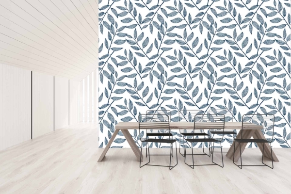 A white wall adorned with blue leafy patterns. The wallpaper features intricate, navy and azure leaves against a crisp white background, evoking a fresh and subtle nautical charm.