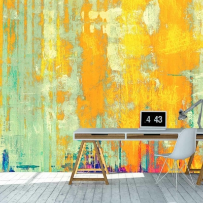 The wallpaper features a vibrant, abstract mural with shades of yellow, orange, and turquoise. It has a distressed texture that suggests it was painted over generations. The interplay of these colors creates a dynamic and energetic backdrop filled with layers and depth.
