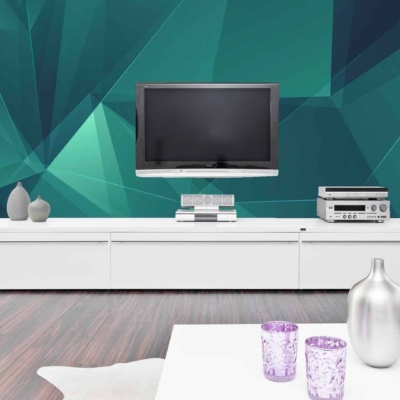 The geometric teal accent wall features interlocking patterns in shades varying from deep teal to light turquoise. The design incorporates sharp angles and clean lines, creating a modern, dynamic look that contrasts with the room’s other elements.