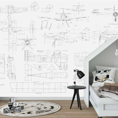 The wallpaper in the child's aviation-themed bedroom features intricate blueprints of vintage airplanes. Highlighted elements include detailed sketches of aircraft components, propeller designs, and fuselage outlines. The color palette primarily consists of soft blues for the blueprint background, contrasted with white and black lines for the technical drawings.