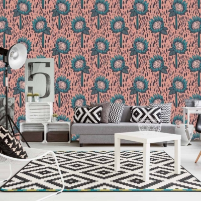 A modern living room with a standout pink and teal floral patterned accent wall. The wallpaper features vibrant pink flowers intertwined with rich teal leaves and intricate details in various shades of green and blue. This dynamic combination of colors adds a lively, yet sophisticated touch to the space.