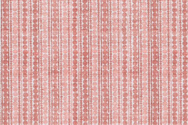 Wallpaper design features vertical lines of variously sized and spaced circles in shades of red and white. The pattern has a woven texture and a fabric-like appearance, with a radiant vibrancy enhancing its allure.