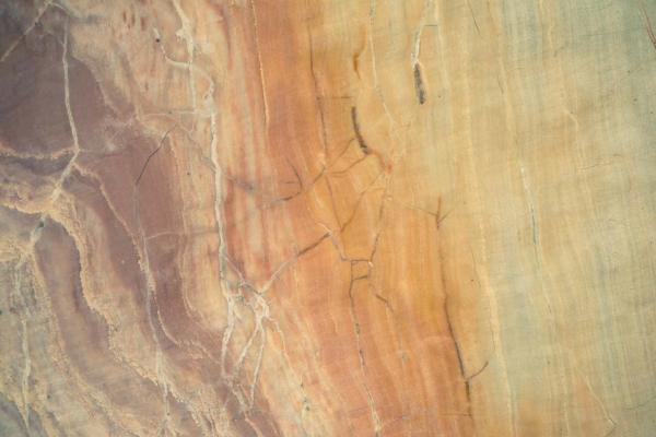 Close-up of marble surface wallpaper featuring an array of colors: earthy tones of brown, orange, and beige. Interwoven with fine, irregular veins and cracks, creating a natural, intricate pattern. Reminiscent of Rainbow Children with vibrant yet grounded hues.
