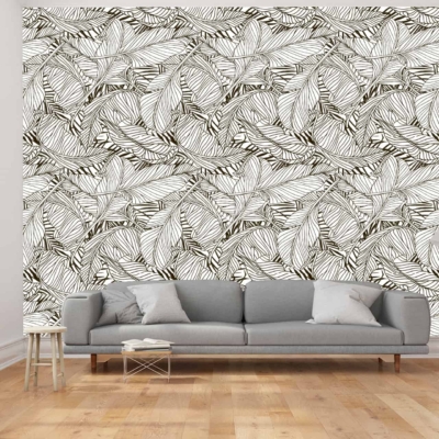 The wallpaper features a bold, black and white leaf pattern. The design consists of large, intricate black leaves set against a crisp white background. The contrast between the black and white creates a striking visual, adding depth and character to the room.