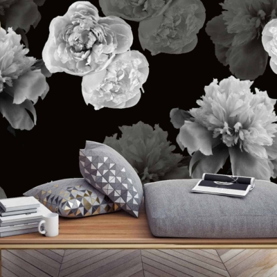 The accent wall boasts bold **black wallpaper** adorned with **oversized grayscale flower prints**, creating a dramatic backdrop. The striking combination of **black** and varying shades of **gray** in the floral design adds depth and visual impact.