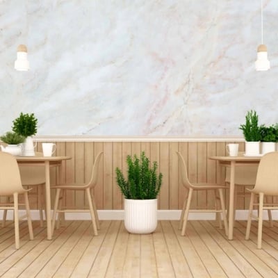 The wallpaper features a marble-like finish, characterized by swirling patterns of whites, grays, and subtle hints of warmer tones like beige. The textural element adds depth and sophistication to the space.